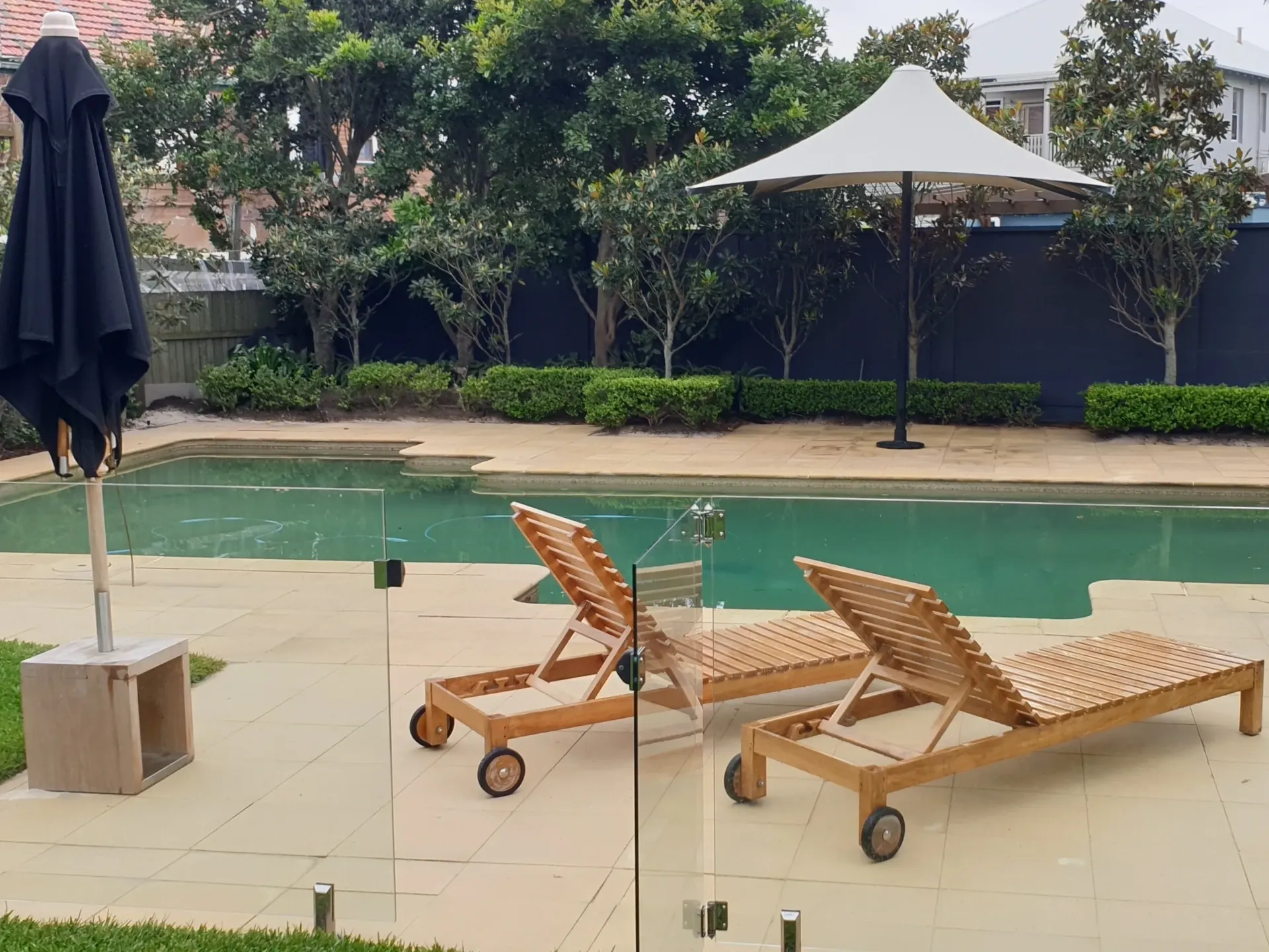Residential poolside and paved outdoor area after professional pressure cleaning