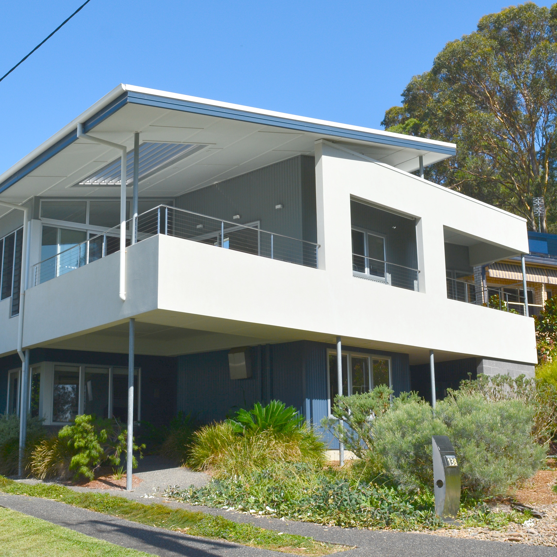 Two-storey contemporary home with a clean, evenly presented exterior and landscaped garden surrounds
